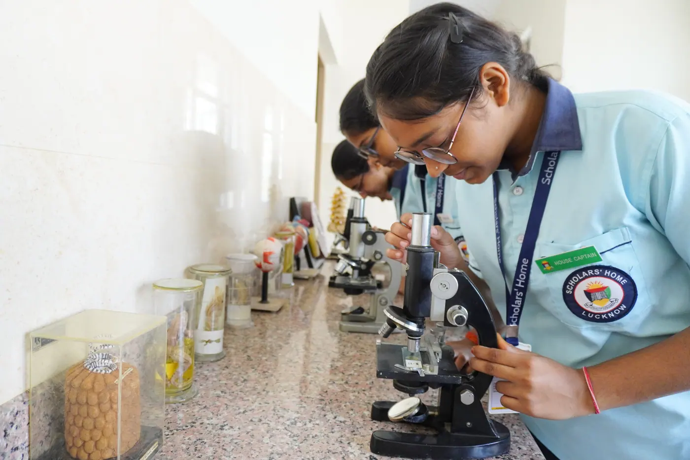 A senior student at the microscope in the science lab